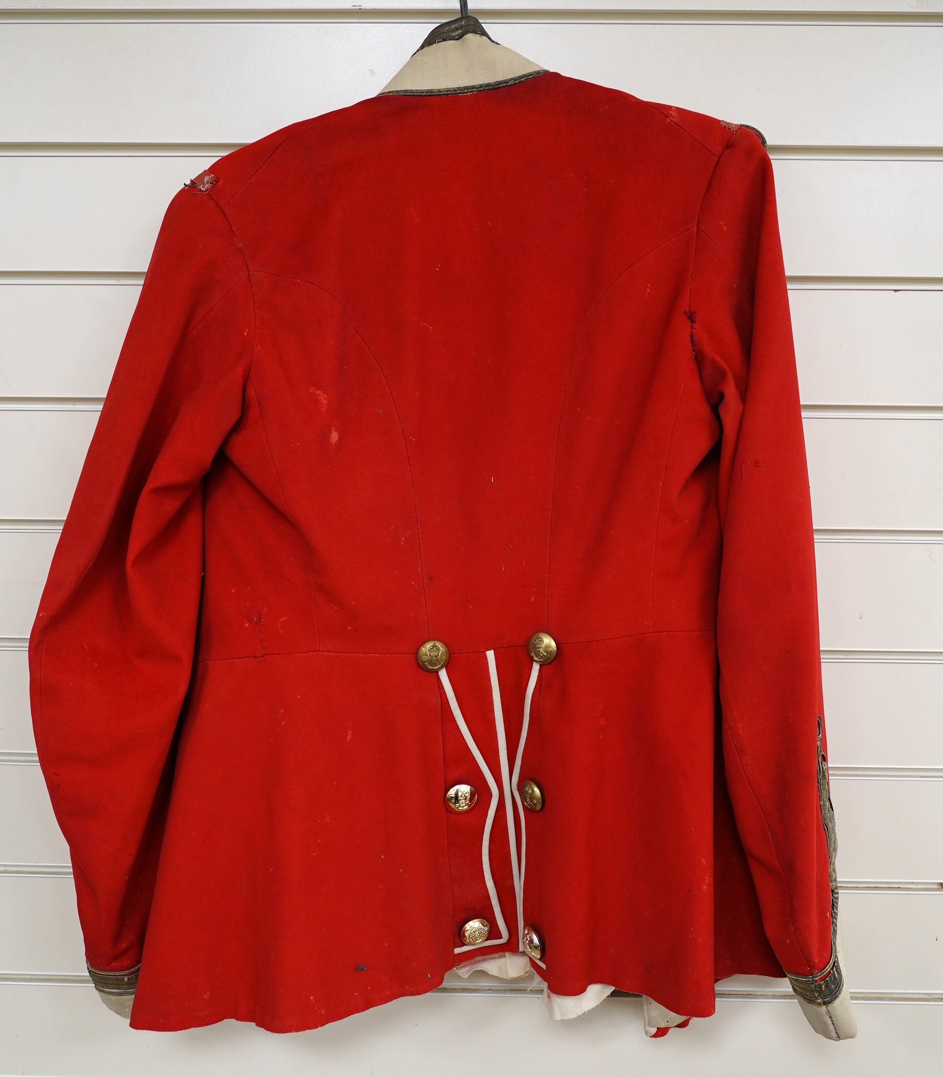 A Sixth Light Infantry officer’s uniform with epaulettes, comprising jacket and dress trousers. Condition - poor to fair, some staining and moth damage, etc.